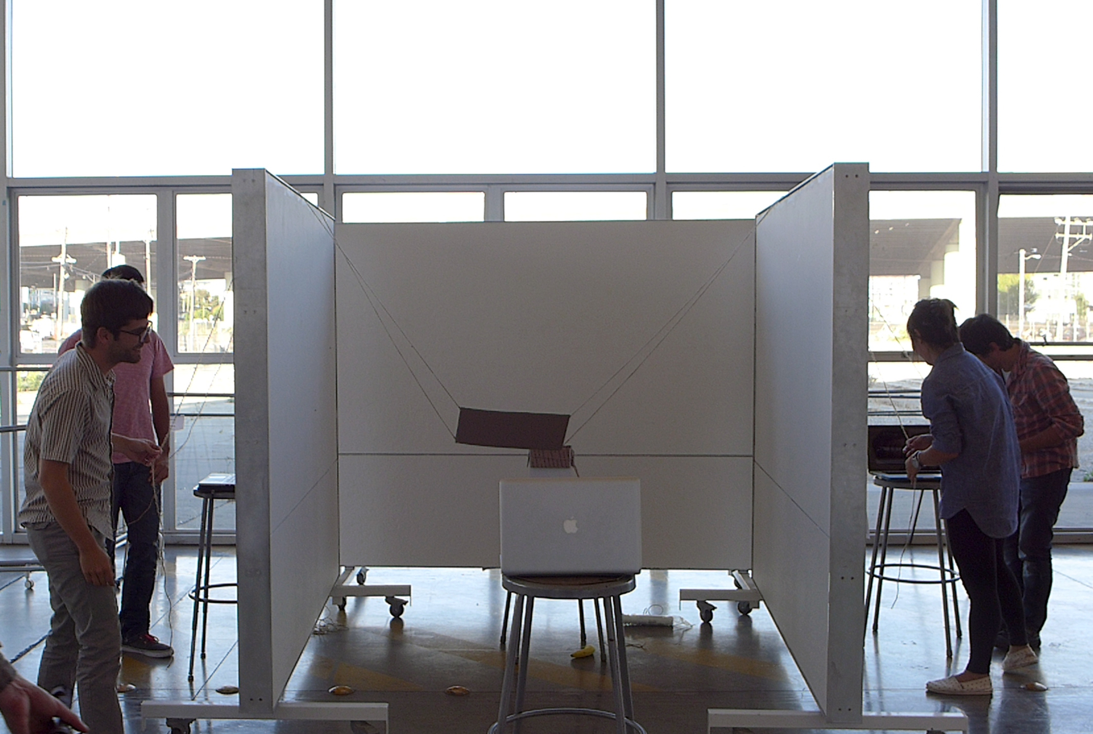 Our first prototype: the \"banana box\" game. Two set of players working together through video from a laptop attempt to put the banana in the box.